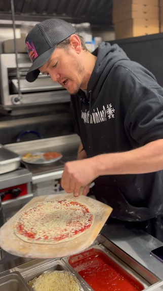 John Hannigan making pizza