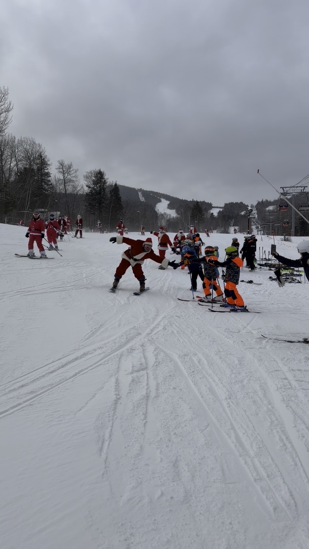 Santa high-fiving kids on the slopes